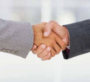 Closeup of a businesspeople shaking hands together