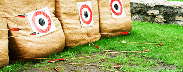 Several arrows on the ground that missed the target