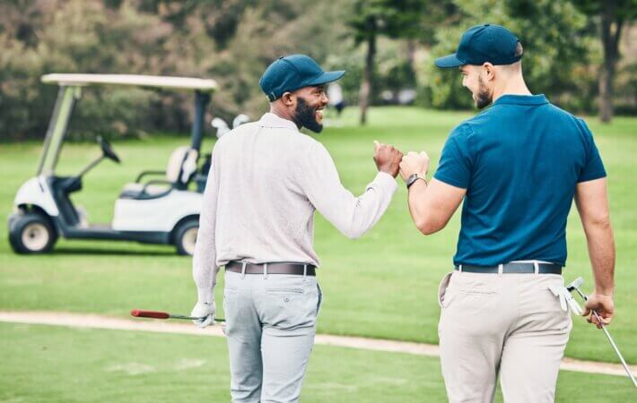 Man,,Friends,And,Fist,Bump,On,Golf,Course,For,Sports,
