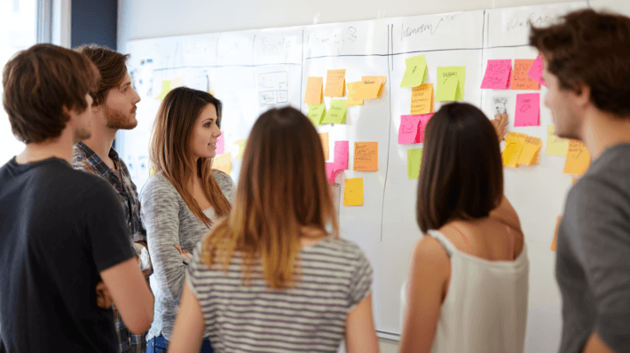 team gathered around w sticky notes